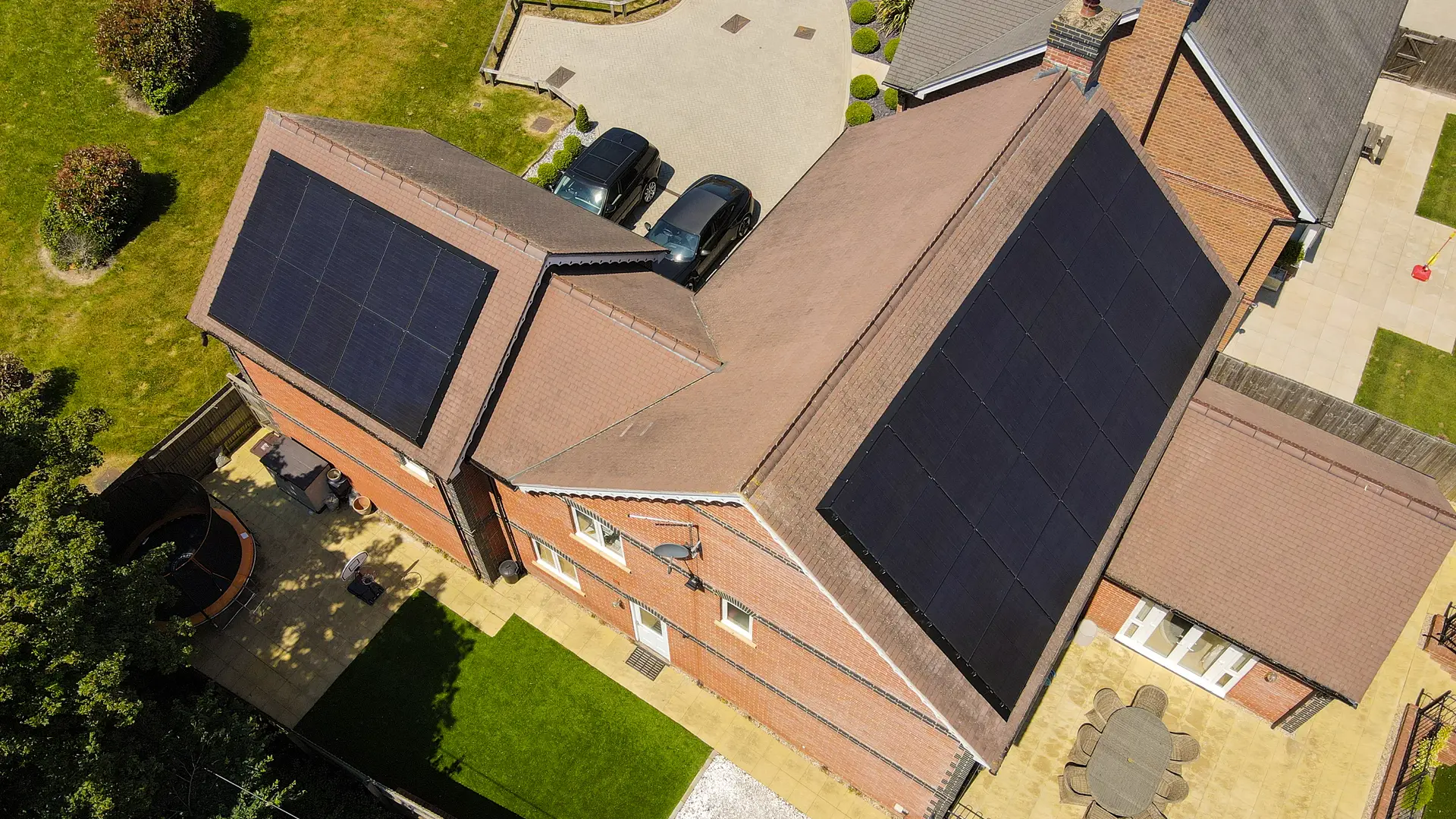 Drone view of a house roof with solar panels