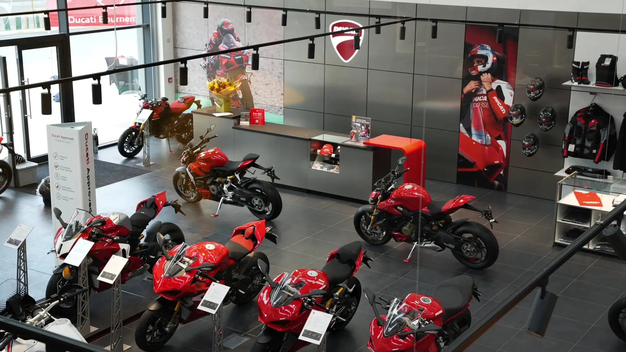 Ducati showroom fit-out with track lighting over a row of motorbikes