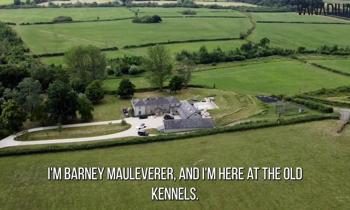 Aerial view of a large rural property with green fields and a newly installed ground-mounted solar array.