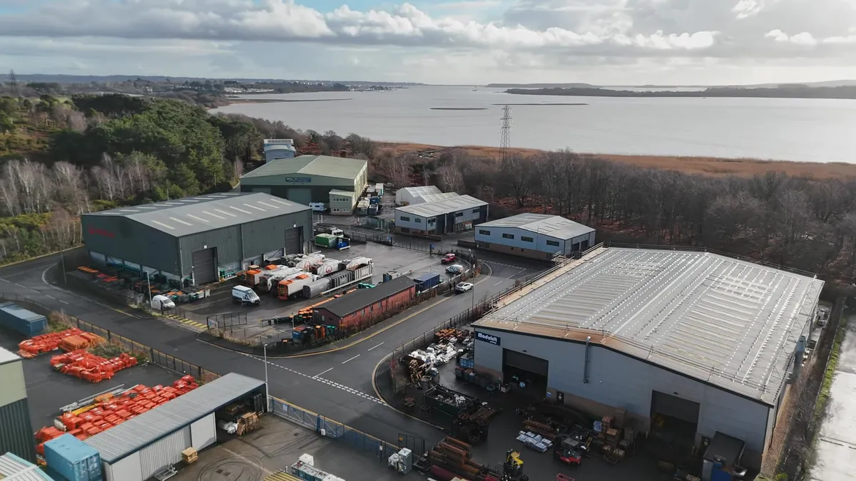 Aerial view of Modulift's commercial premises in Wimborne, Dorset, showing the large industrial buildings and surrounding landscape.