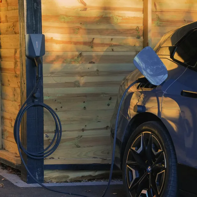 Easee One charger installed on the wall of a house