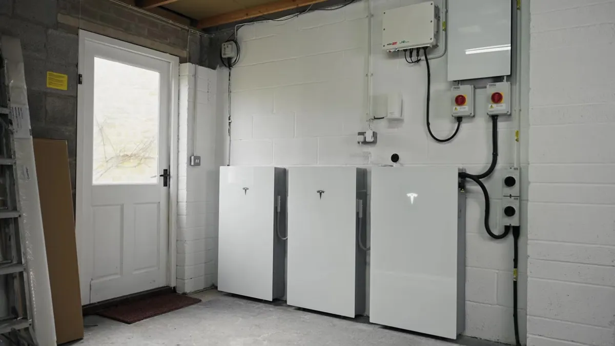 Garage wall with a Tesla Powerwall 3, expansion packs and a SolarEdge inverter