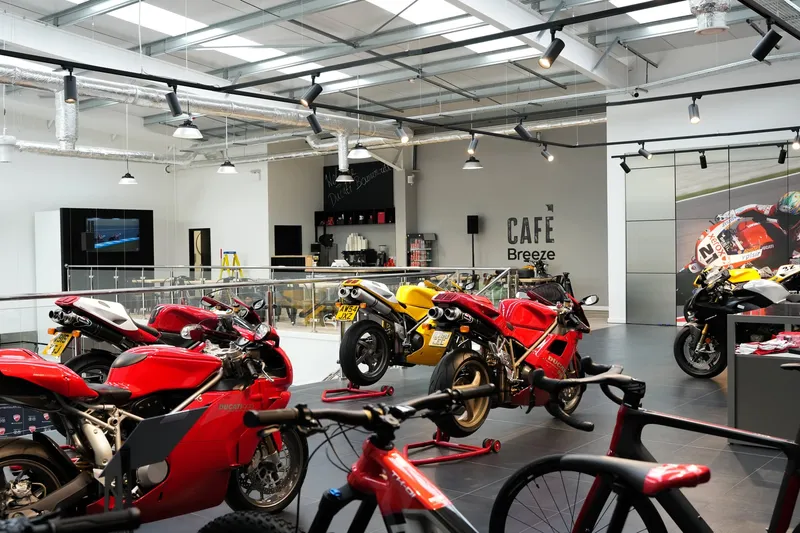 Ducati Bournemouth showroom floor with track lighting and the café mezzanine