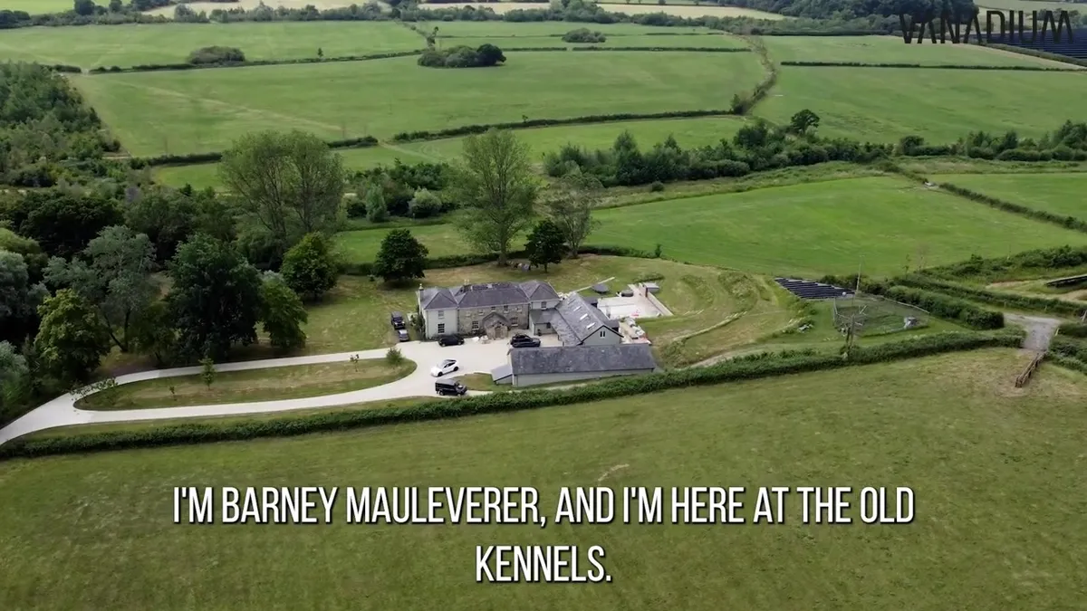 Aerial view of a large rural property with green fields and a newly installed ground-mounted solar array.