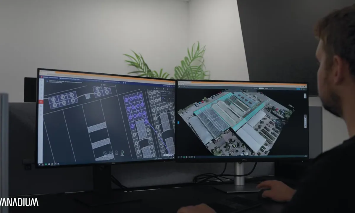 Vanadium designer viewing a 3D solar model of a commercial site on dual screens