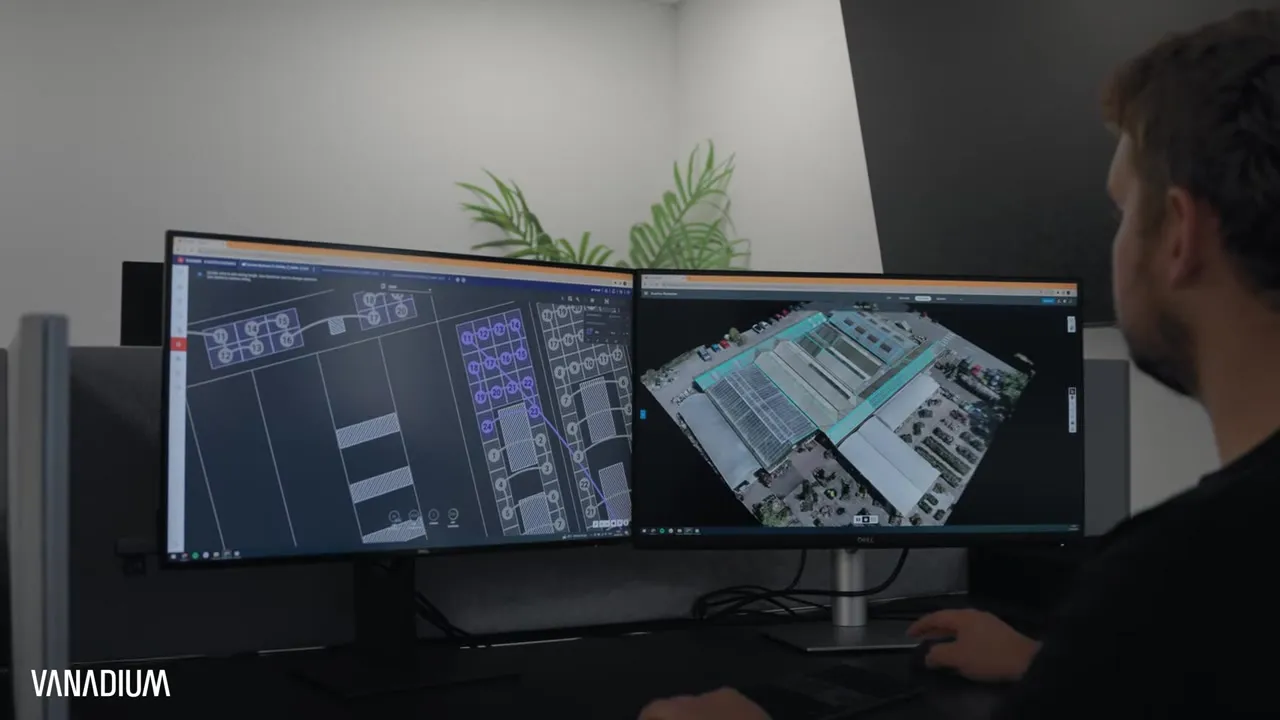 Vanadium designer viewing a 3D solar model of a commercial site on dual screens