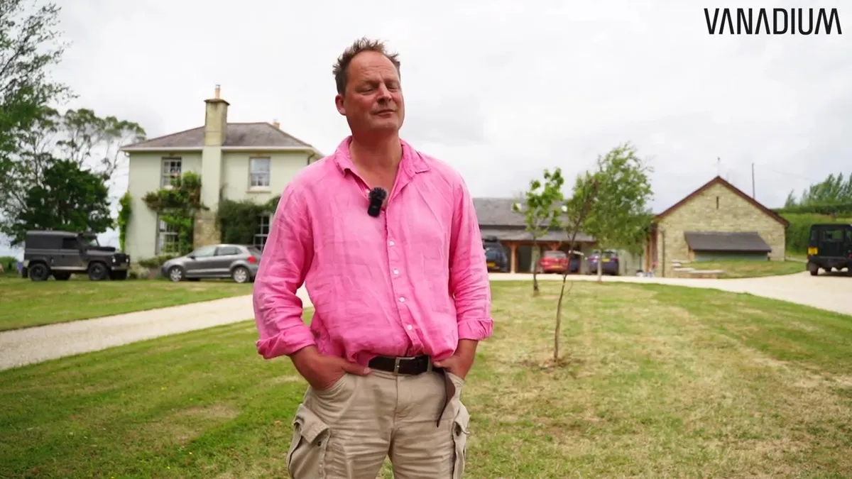 The homeowner speaking to the camera with his rural property in the background.