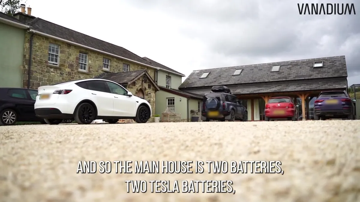 Two white Tesla Powerwall batteries mounted on a wall in a utility room.