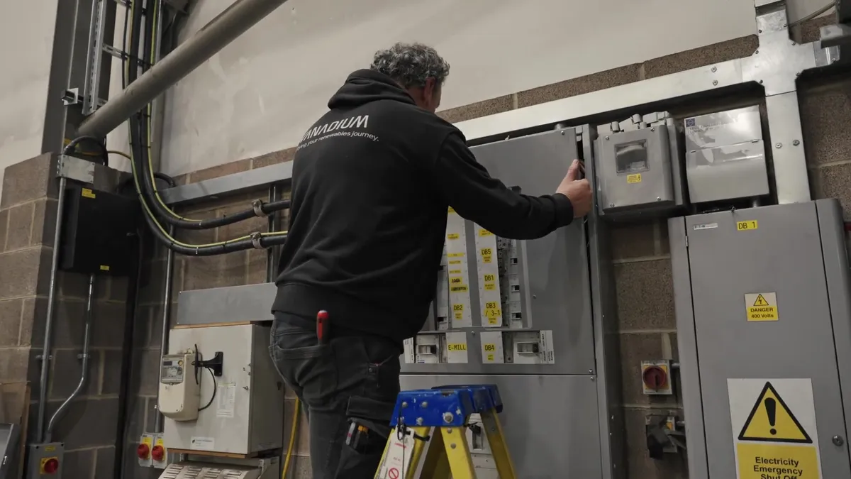 Electrician working on an electrical panel inside the Modulift by Pewag building