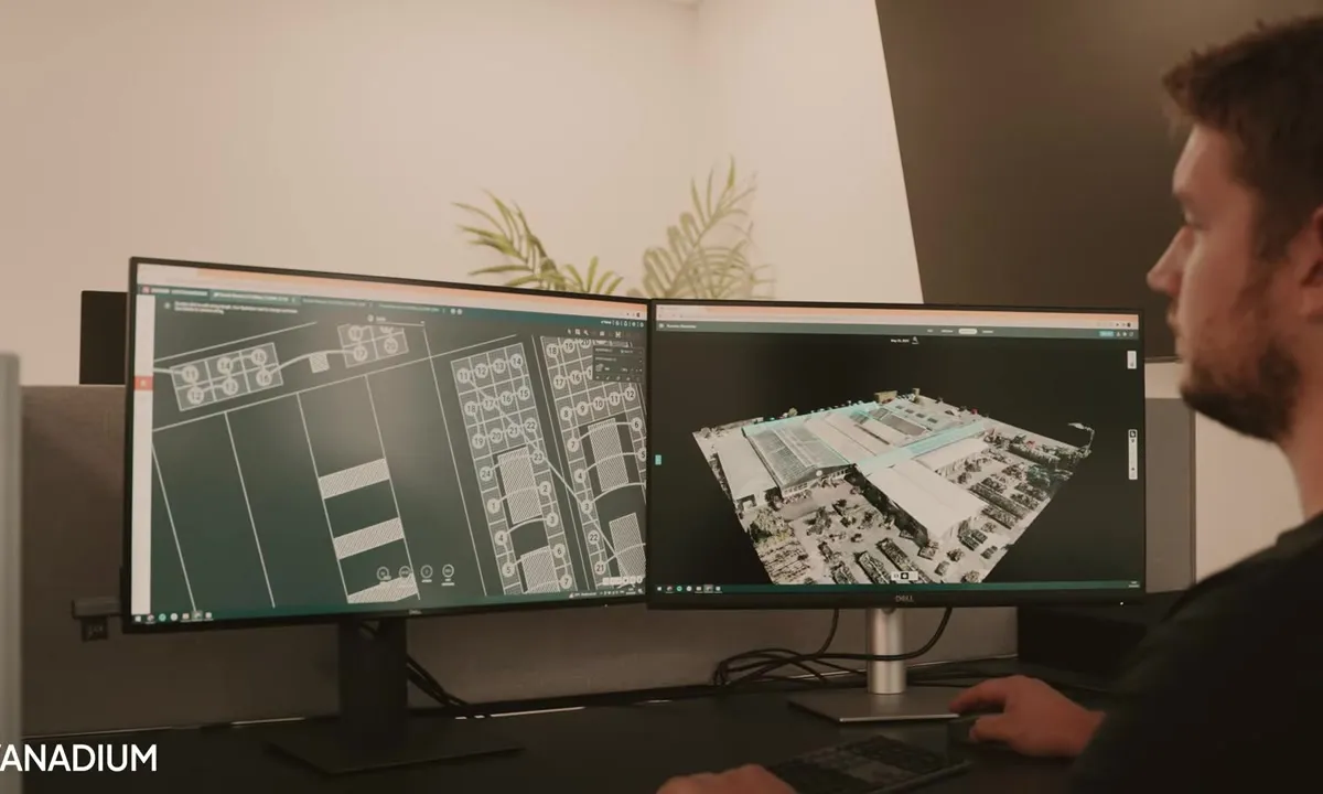 Vanadium designer laying out a solar array on a dual-monitor workstation